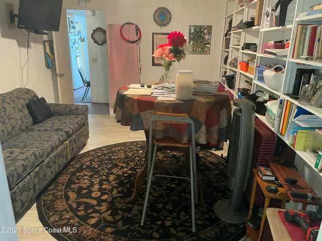 a living room with furniture and a book shelf