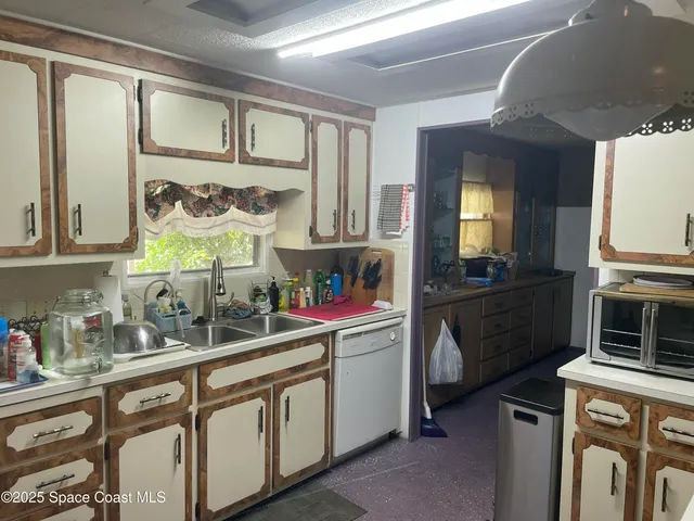 a kitchen with cabinets and window