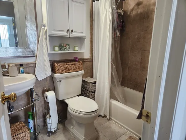 a white toilet sitting next to a bathroom sink