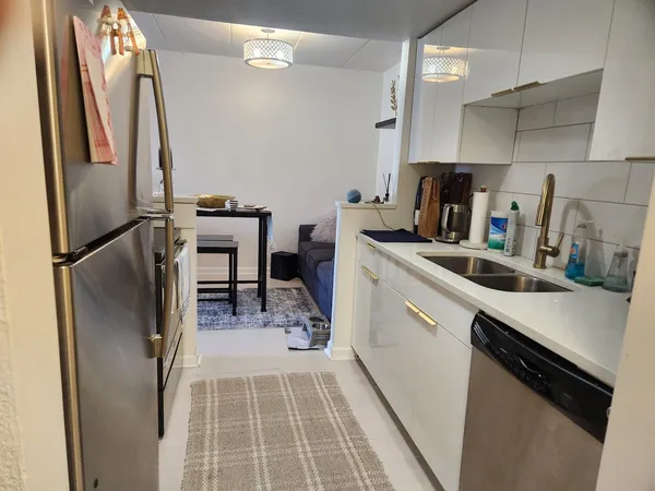 a kitchen with refrigerator and cabinets