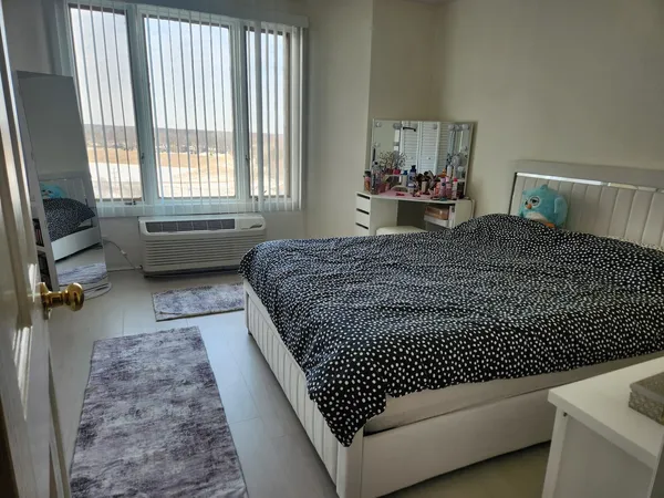 a bedroom with a bed and window