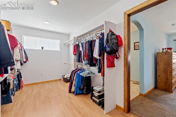 a view of walk in closet with clothes