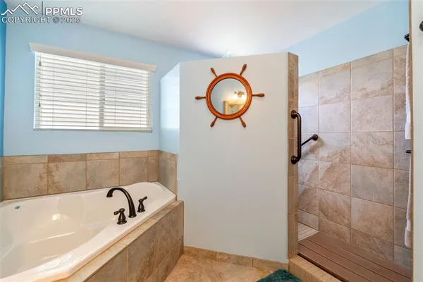 a bathroom with a tub and a window