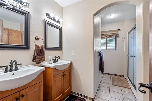 a bathroom with 2 sink and a mirror