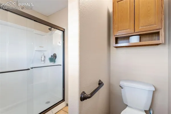 a bathroom with a toilet a sink and a window
