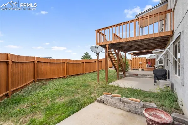 a view of a backyard with wooden fence