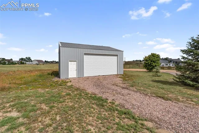 a view of a big room with floor to ceiling windows and yard