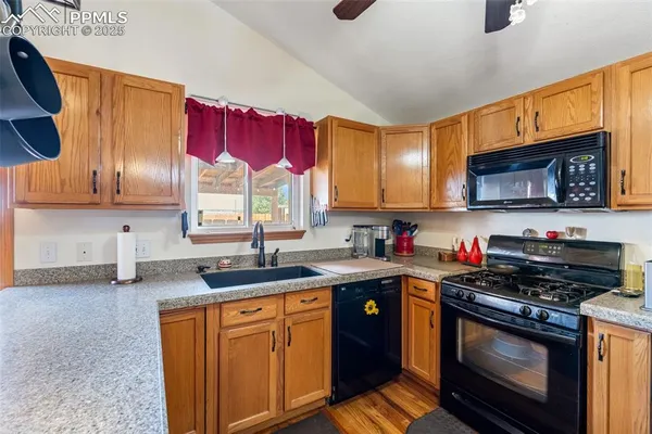 a kitchen with stainless steel appliances granite countertop a sink stove microwave and cabinets