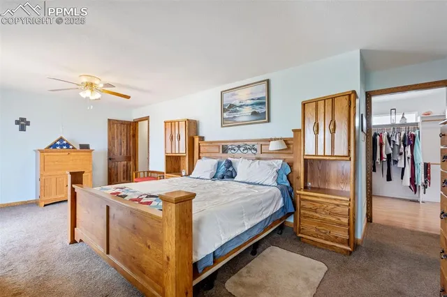 a bedroom with a bed and a refrigerator