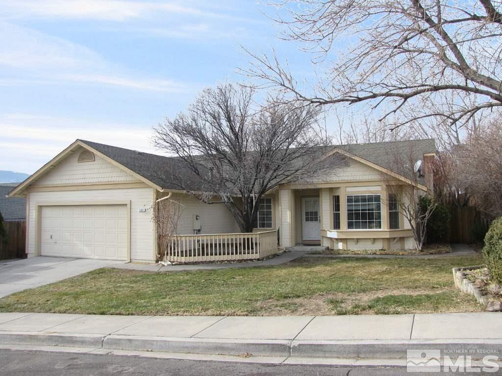 a front view of a house with a garden and trees