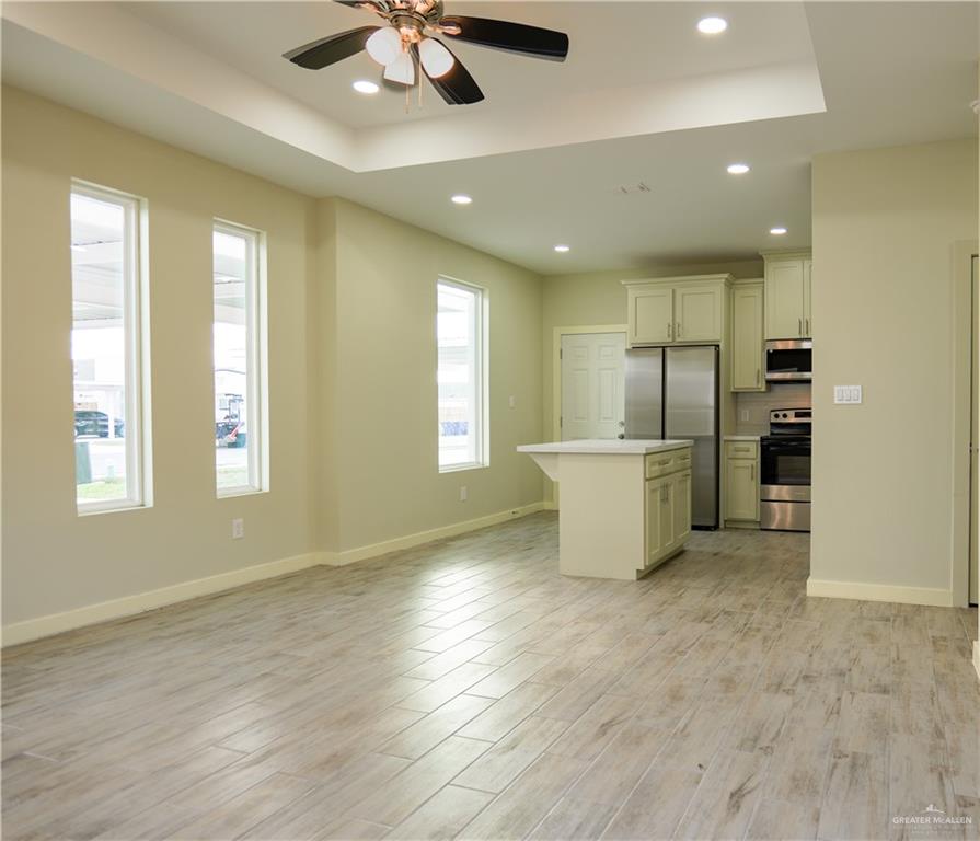3086 Briggs Road, Unit D Weslaco, TX 78596 - Photo 3 of 10 a view of an empty room with a window and kitchen view