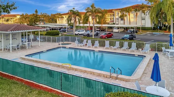 a view of a lake with a yard from a balcony
