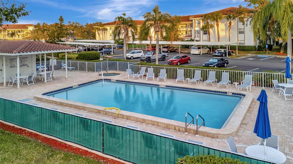 6507 Stone River Road, Unit 105 Bradenton, FL 34203 - Photo 12 of 62 a view of a swimming pool with a lounge chairs