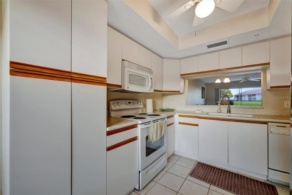 6507 Stone River Road, Unit 105 Bradenton, FL 34203 - Photo 32 of 62 a kitchen with stainless steel appliances granite countertop a sink and cabinets