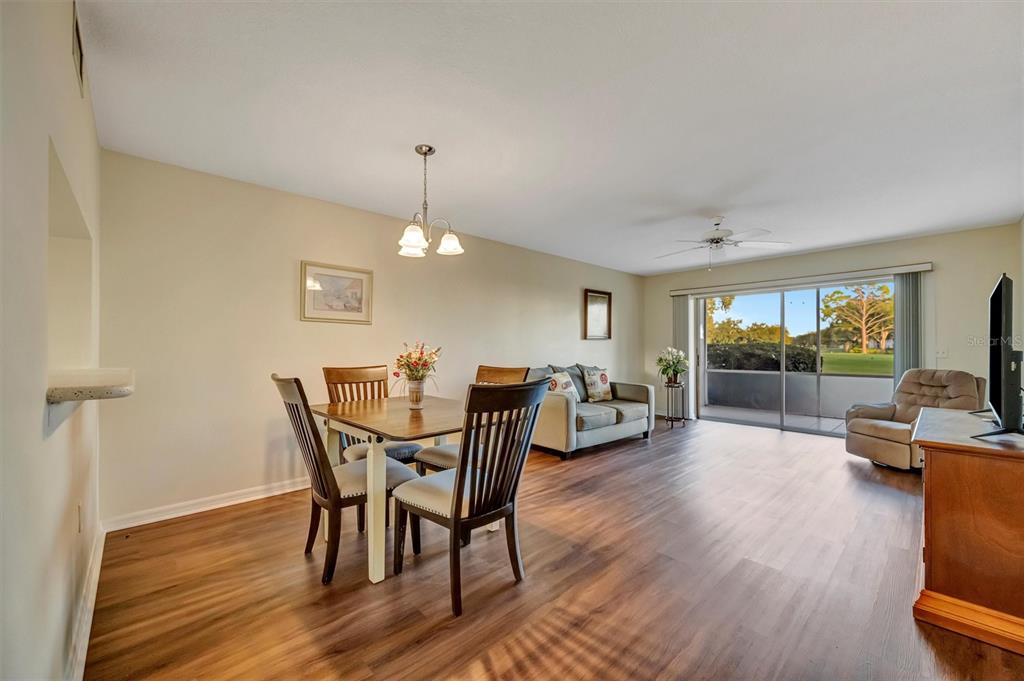 6507 Stone River Road, Unit 105 Bradenton, FL 34203 - Photo 38 of 62 a view of a dining room with furniture and wooden floor
