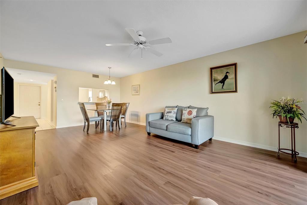 6507 Stone River Road, Unit 105 Bradenton, FL 34203 - Photo 43 of 62 a living room with furniture and wooden floor