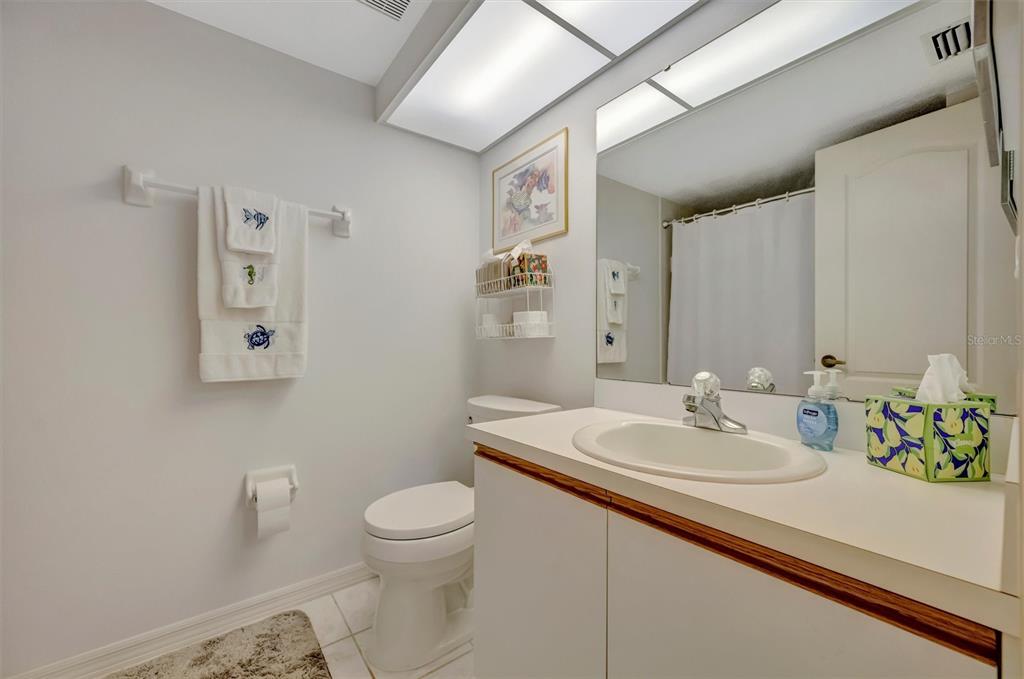 6507 Stone River Road, Unit 105 Bradenton, FL 34203 - Photo 57 of 62 a bathroom with a sink a toilet and mirror