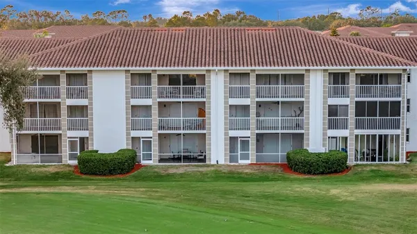 a front view of a residential apartment building with a yard