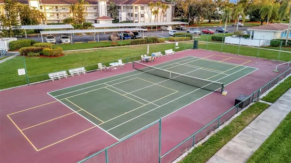 a view of a swimming pool with a chair and tables in the patio