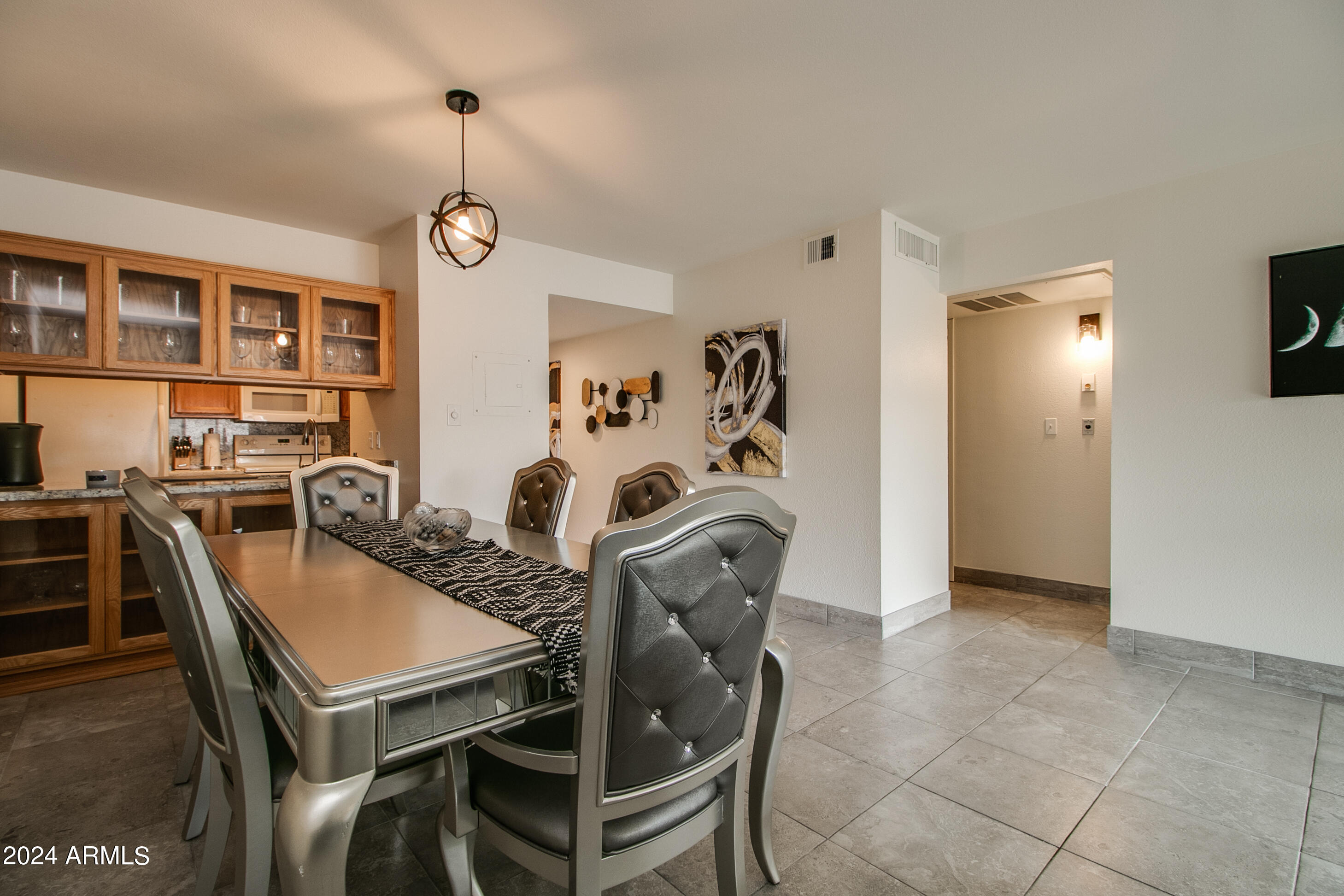 7625 East Camelback Road, Unit 252B Scottsdale, AZ 85251 - Photo 13 of 26 a view of a dining room with furniture and a chandelier