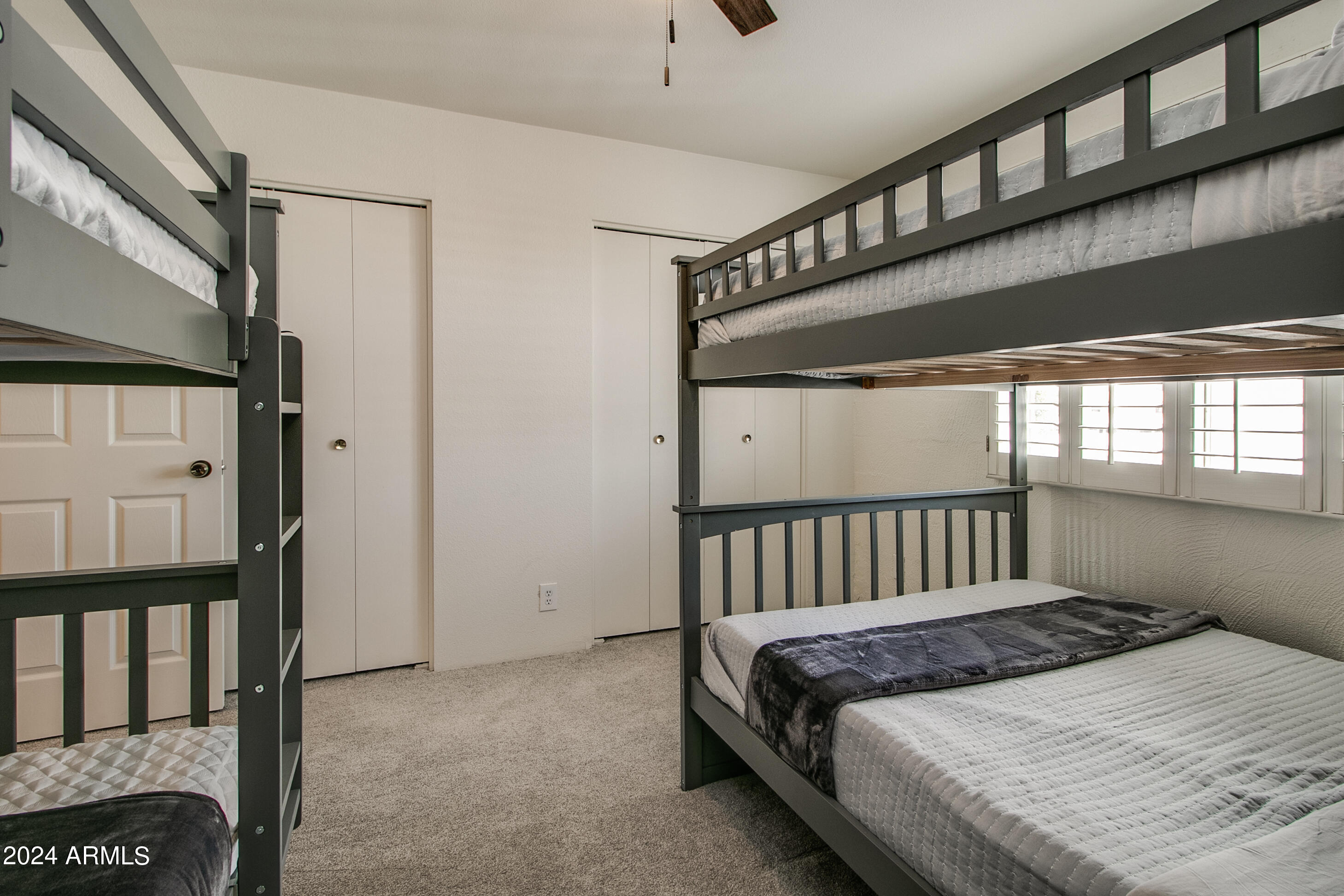7625 East Camelback Road, Unit 252B Scottsdale, AZ 85251 - Photo 19 of 26 a bed sitting in a bedroom next to a window
