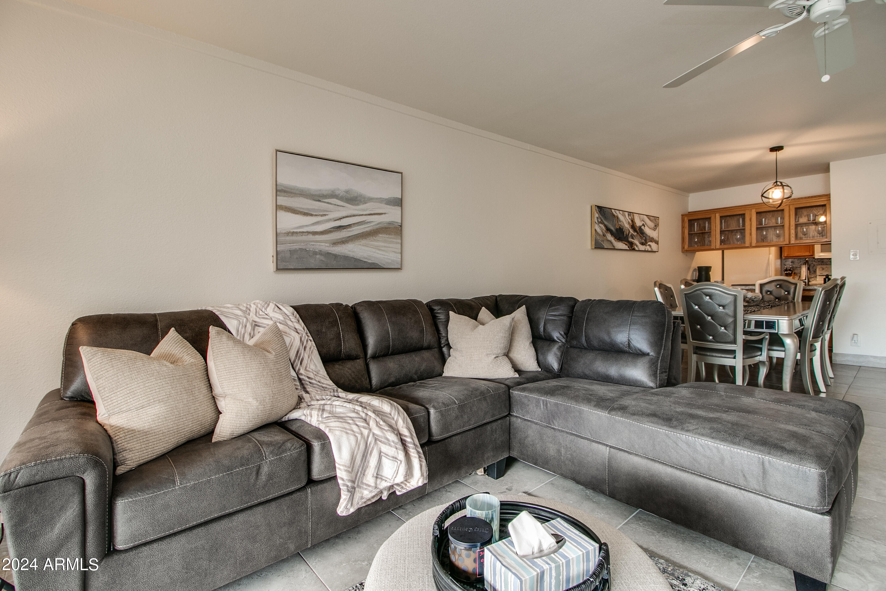 7625 East Camelback Road, Unit 252B Scottsdale, AZ 85251 - Photo 2 of 26 a living room with furniture a rug and a chandelier