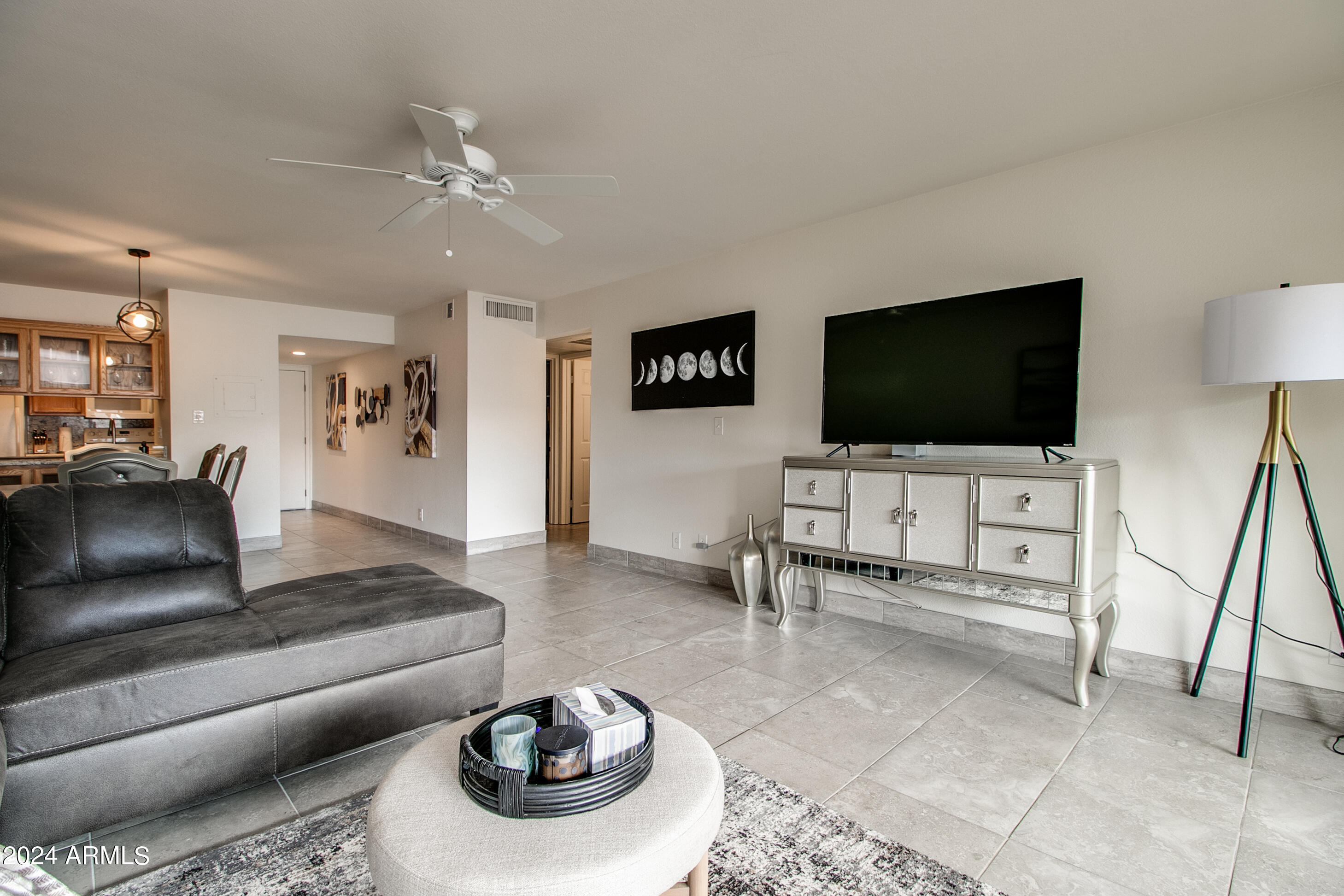 7625 East Camelback Road, Unit 252B Scottsdale, AZ 85251 - Photo 21 of 26 a living room with furniture and a flat screen tv