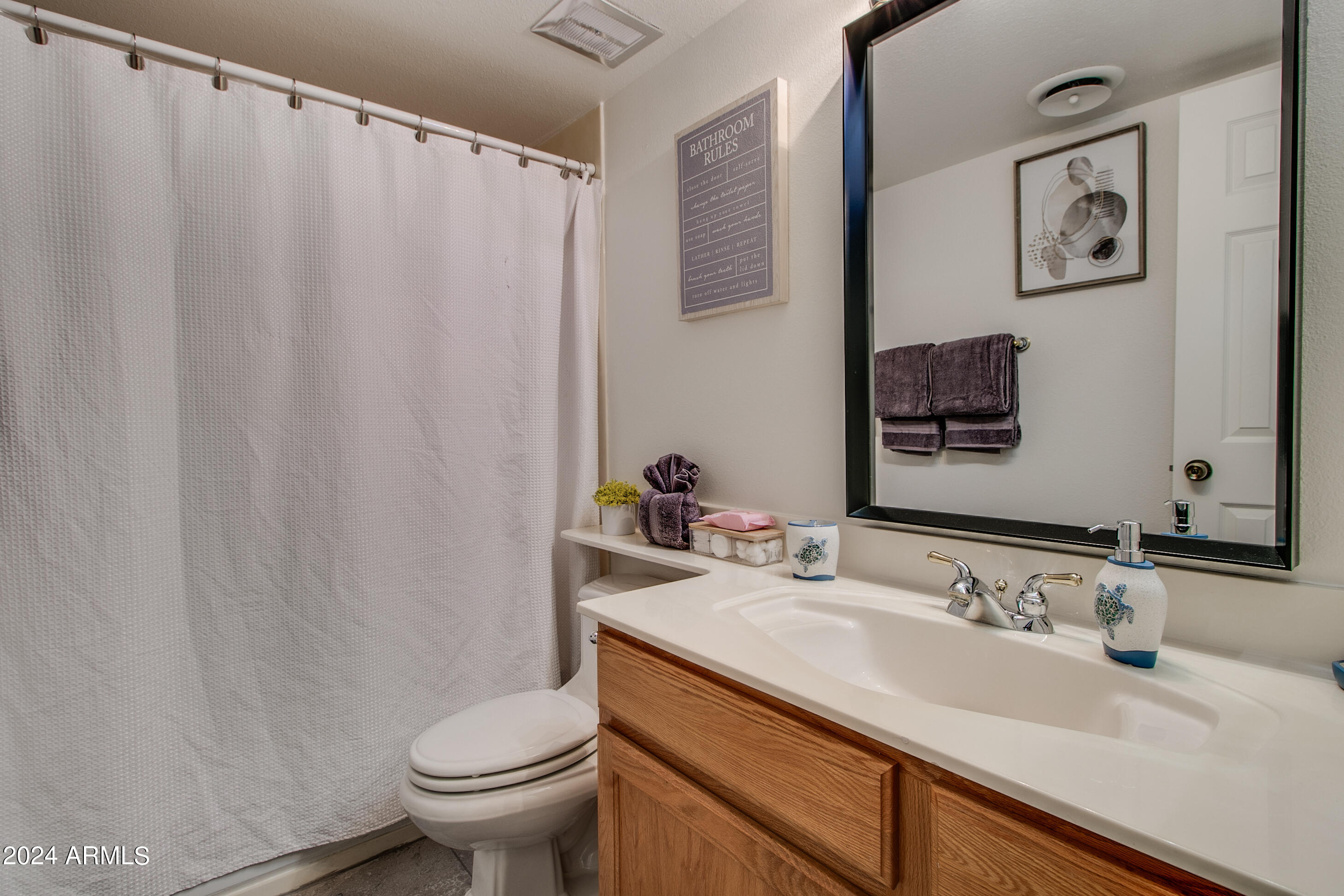 7625 East Camelback Road, Unit 252B Scottsdale, AZ 85251 - Photo 22 of 26 a bathroom with a granite countertop sink toilet and a mirror