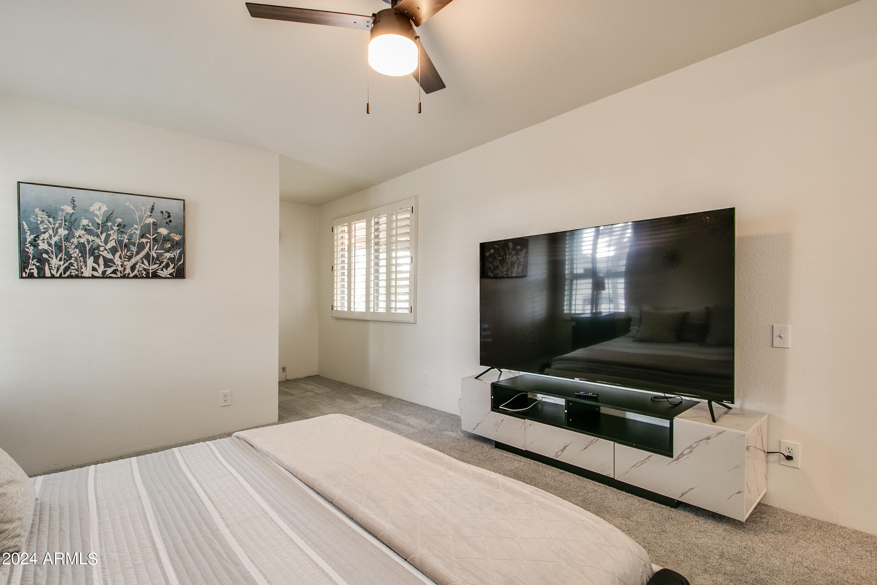 7625 East Camelback Road, Unit 252B Scottsdale, AZ 85251 - Photo 26 of 26 a bedroom with furniture and flat screen tv
