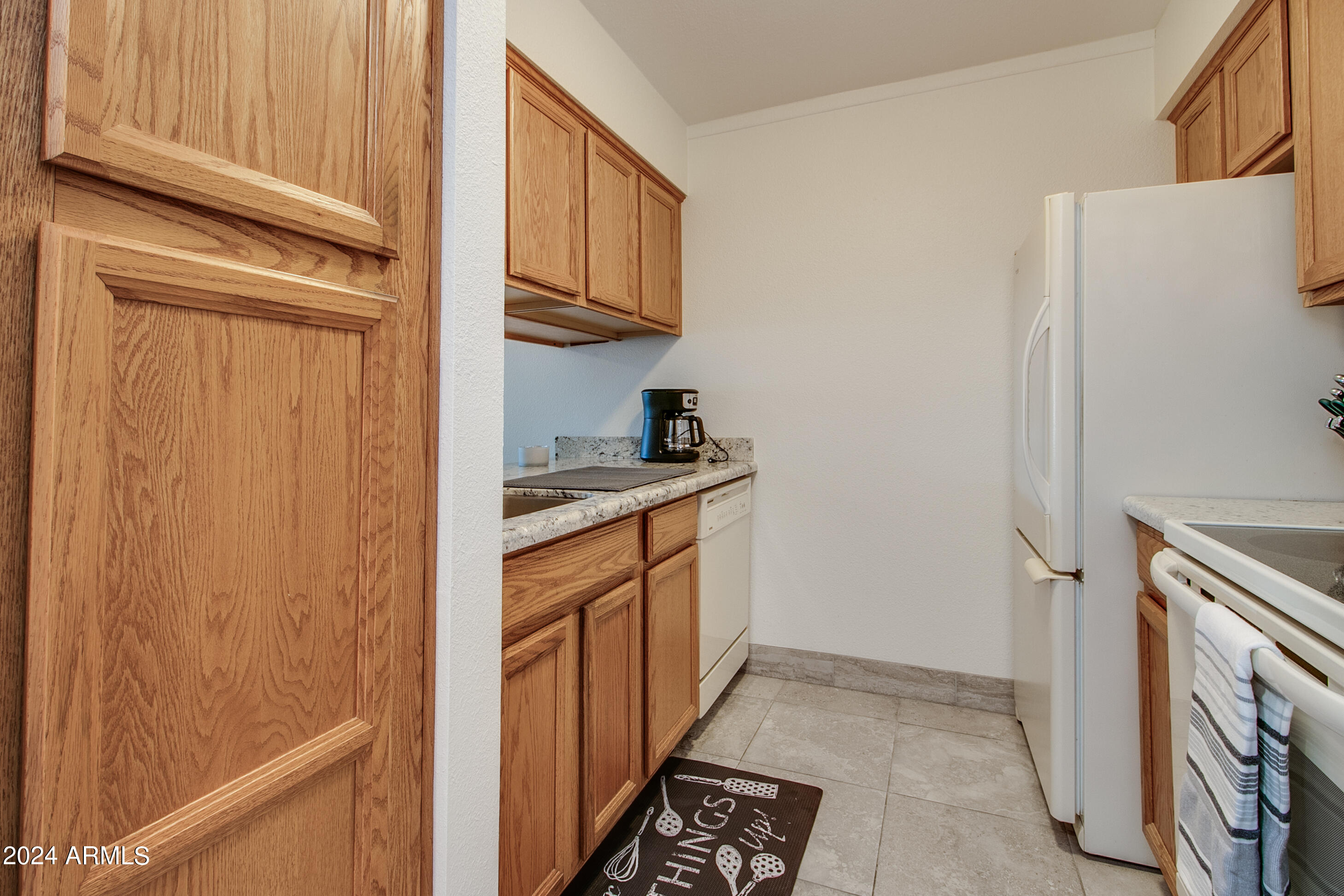 7625 East Camelback Road, Unit 252B Scottsdale, AZ 85251 - Photo 6 of 26 a kitchen with stainless steel appliances granite countertop a refrigerator and a stove