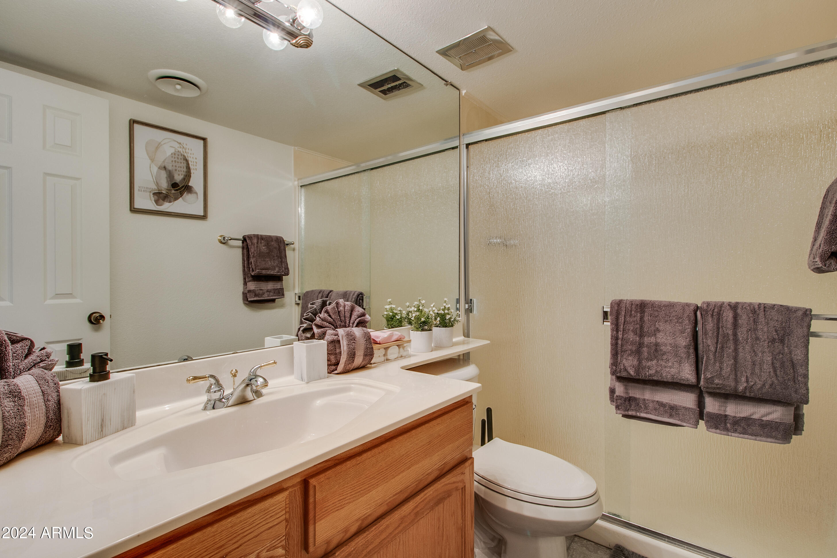 7625 East Camelback Road, Unit 252B Scottsdale, AZ 85251 - Photo 7 of 26 a bathroom with a sink vanity mirror and toilet