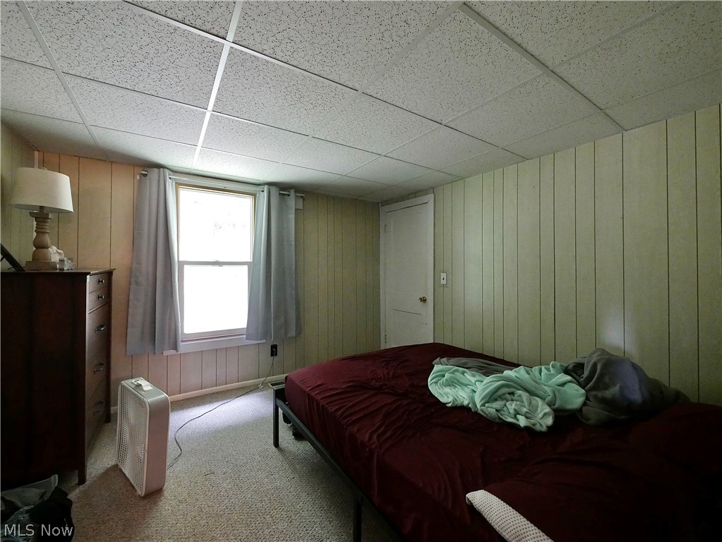 75450 Fair Road Freeport, OH 43973 - Photo 37 of 45 Carpeted bedroom with wood walls and a paneled ceiling