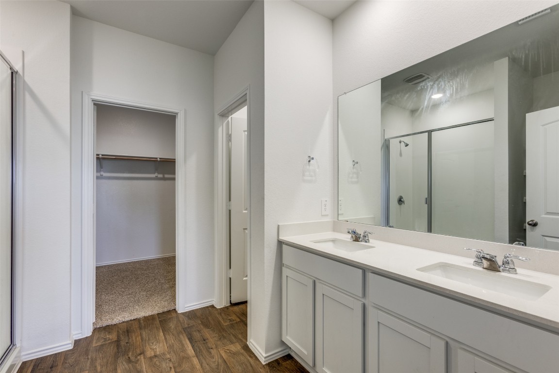 543 Sandringham Loop Kyle, TX 78640 - Photo 13 of 20 a bathroom with a sink and a mirror