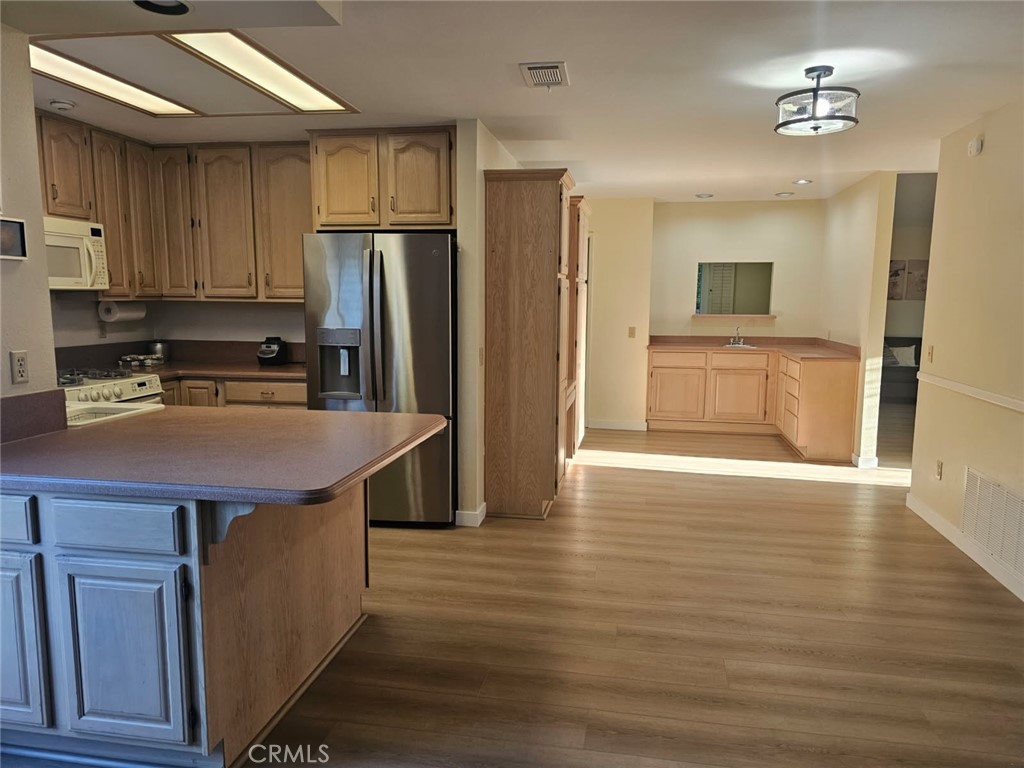25132 Highspring Avenue Newhall, CA 91321 - Photo 11 of 46 a kitchen with kitchen island a sink appliances and cabinets