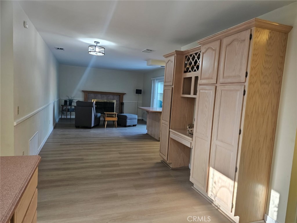 25132 Highspring Avenue Newhall, CA 91321 - Photo 12 of 46 a view of a hallway with wooden floor and furniture