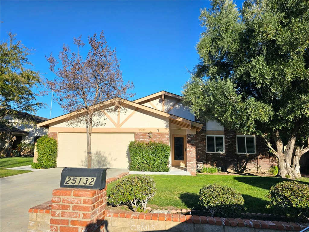 25132 Highspring Avenue Newhall, CA 91321 - Photo 2 of 46 a front view of a house with garden