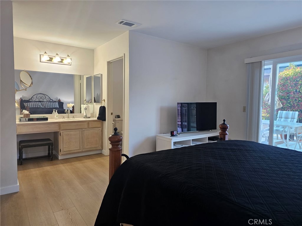 25132 Highspring Avenue Newhall, CA 91321 - Photo 22 of 46 a bedroom with a bed and a flat screen tv