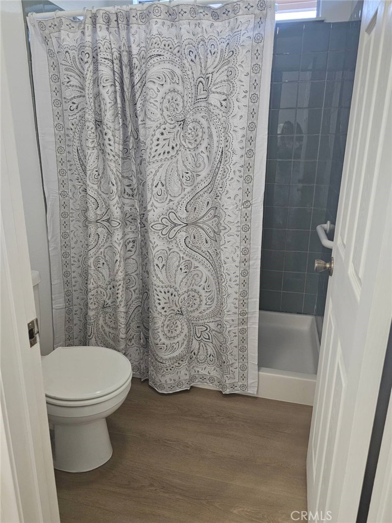 25132 Highspring Avenue Newhall, CA 91321 - Photo 25 of 46 a white toilet sitting next to a bath tub and a shower