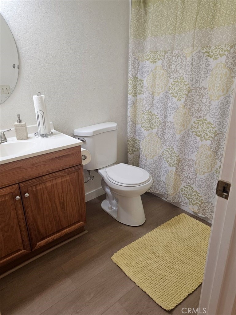 25132 Highspring Avenue Newhall, CA 91321 - Photo 29 of 46 a bathroom with a sink a toilet and a mirror