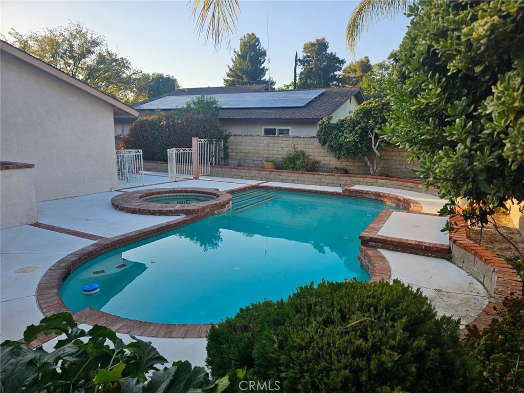 25132 Highspring Avenue Newhall, CA 91321 - Photo 32 of 46 a view of a swimming pool with a yard