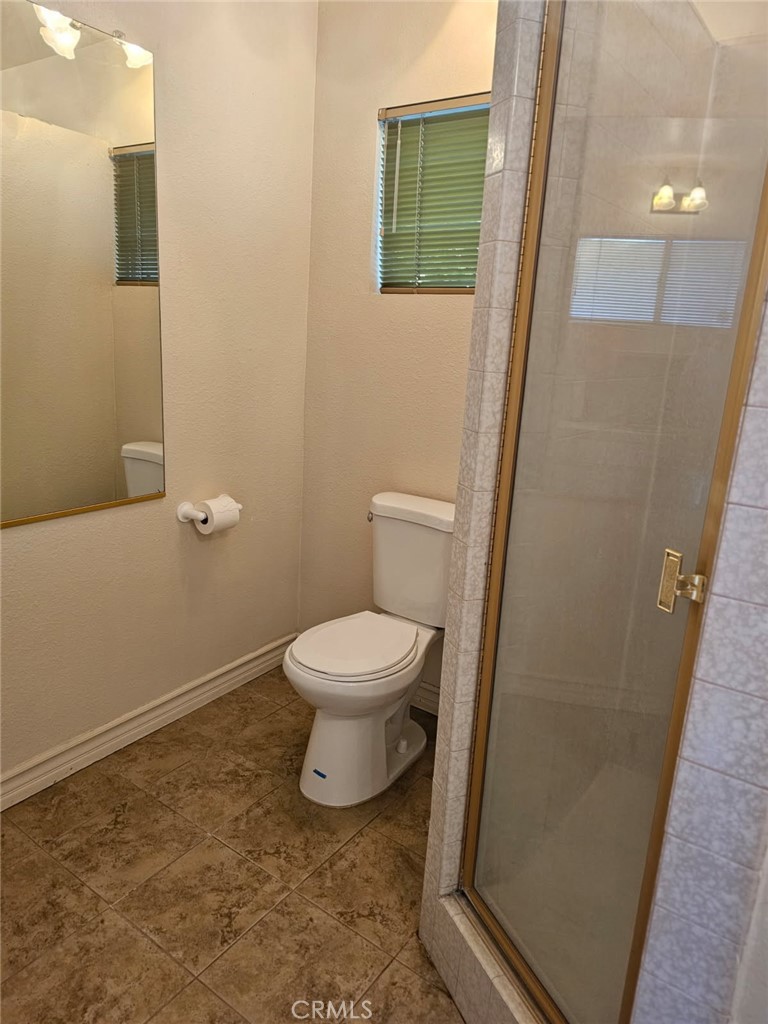 25132 Highspring Avenue Newhall, CA 91321 - Photo 38 of 46 a white toilet sitting next to a sink