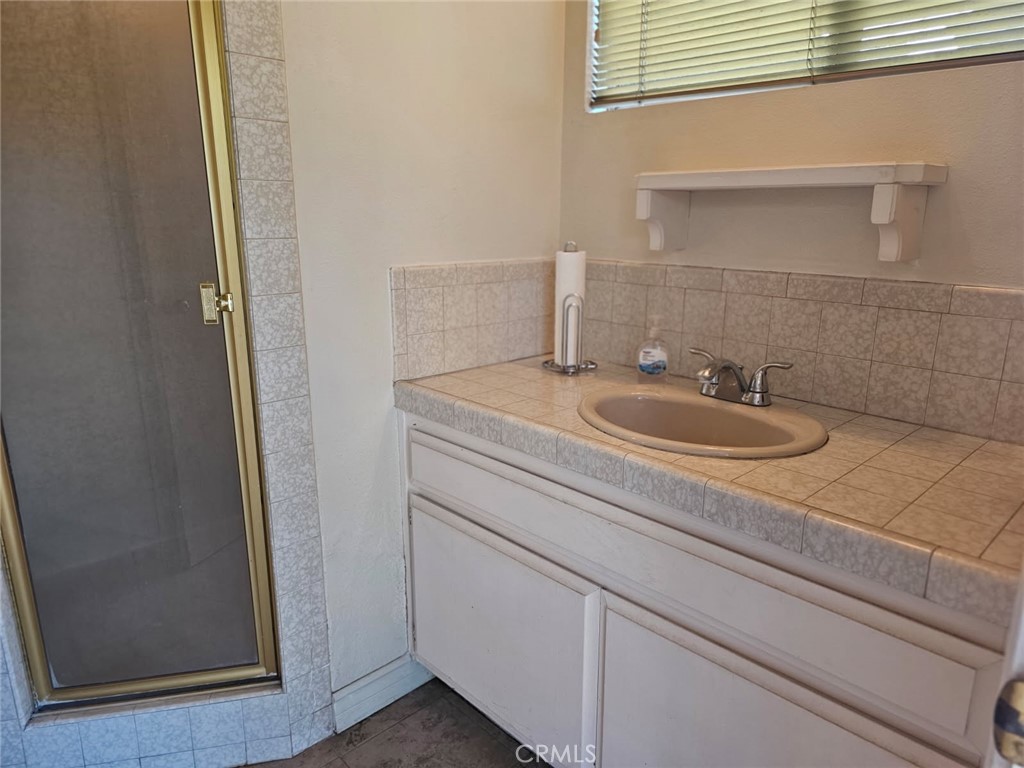 25132 Highspring Avenue Newhall, CA 91321 - Photo 39 of 46 a bathroom with a sink and a mirror