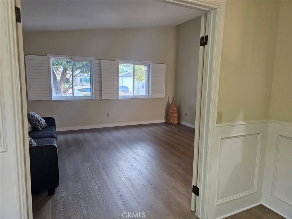 25132 Highspring Avenue Newhall, CA 91321 - Photo 5 of 46 an empty room with wooden floor and windows