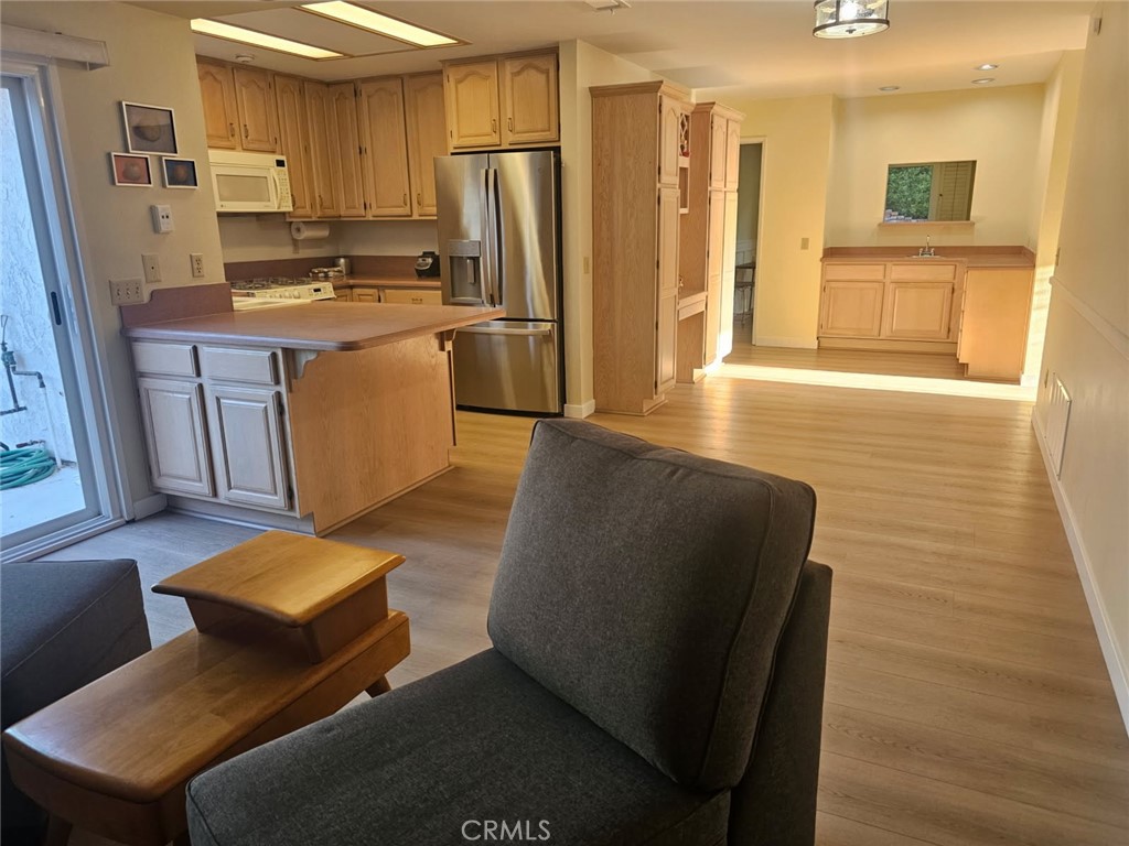 25132 Highspring Avenue Newhall, CA 91321 - Photo 7 of 46 a living room with stainless steel appliances kitchen island granite countertop furniture and a refrigerator