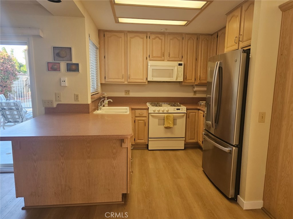 25132 Highspring Avenue Newhall, CA 91321 - Photo 9 of 46 a kitchen with a refrigerator sink and stove
