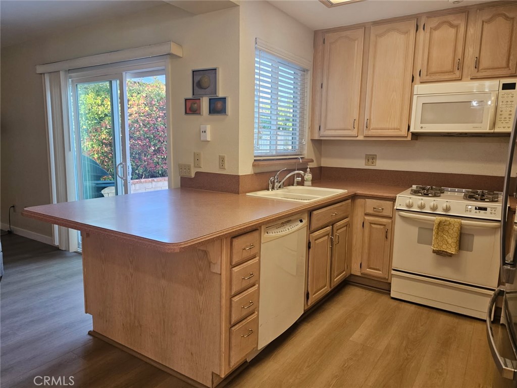 25132 Highspring Avenue Newhall, CA 91321 - Photo 10 of 46 a kitchen with white cabinets and white appliances