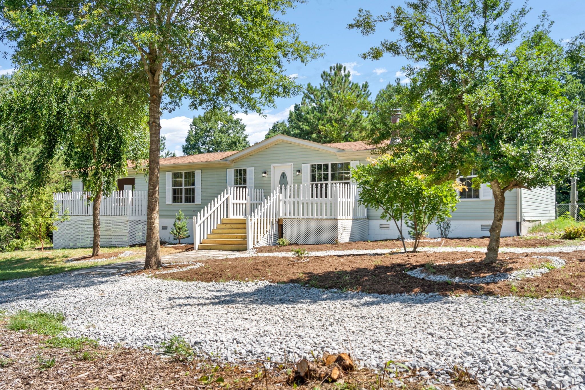 107 Holland Road Dickson, TN 37055 - Photo 1 of 31 a view of a white house with a yard and large tree