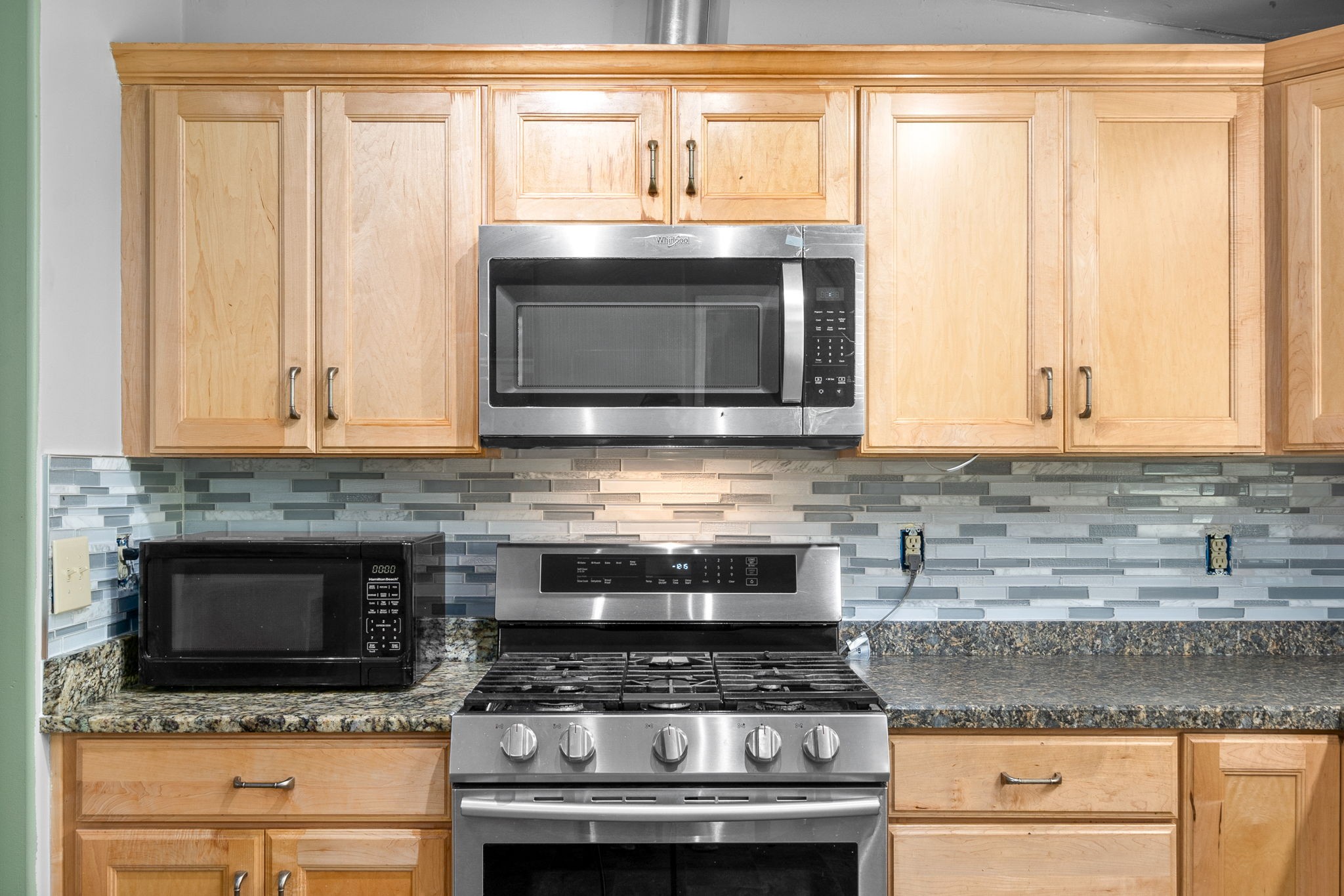 107 Holland Road Dickson, TN 37055 - Photo 11 of 31 a kitchen with granite countertop a stove top oven microwave and cabinets