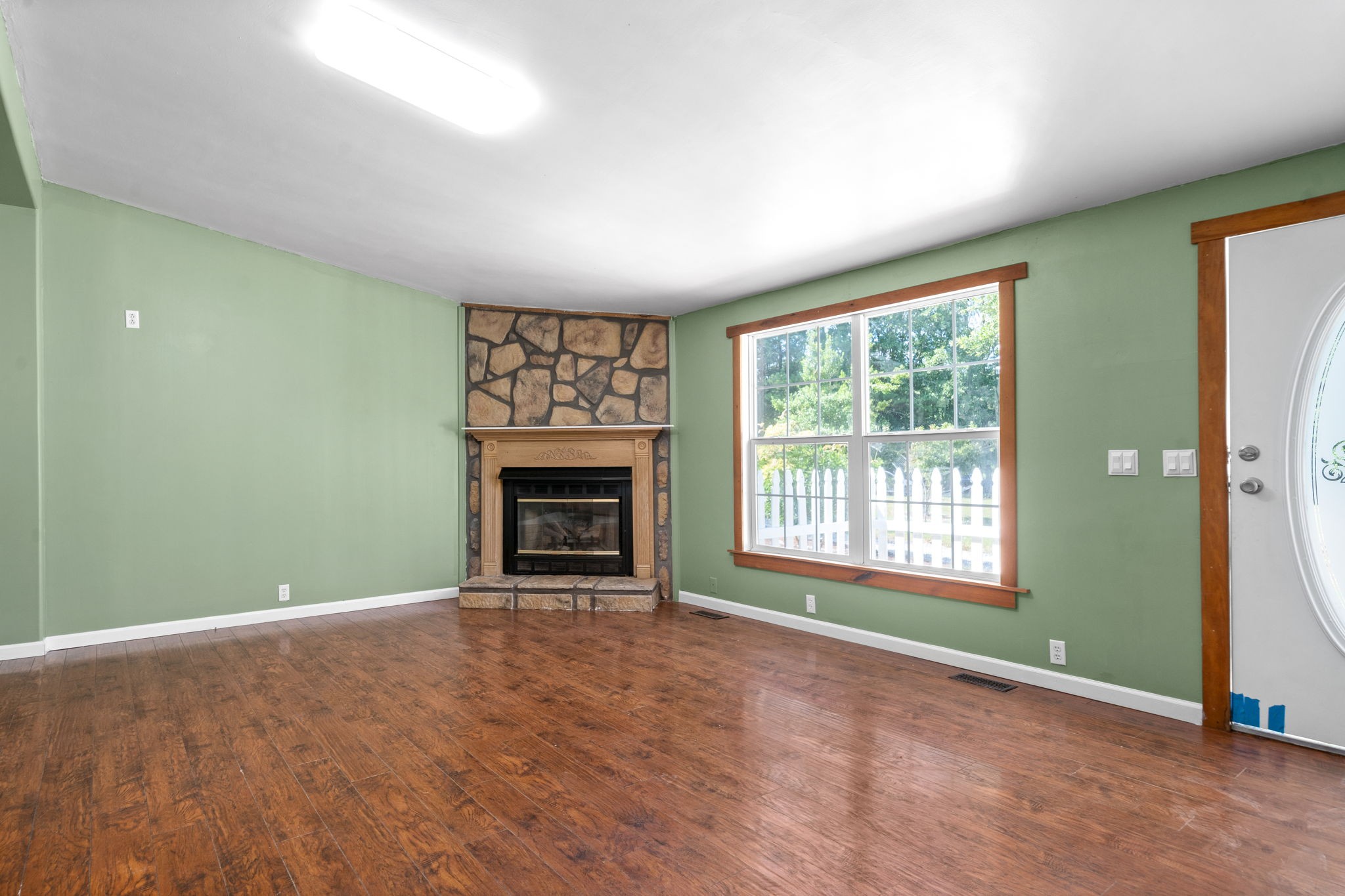 107 Holland Road Dickson, TN 37055 - Photo 4 of 31 an empty room with a fireplace and window