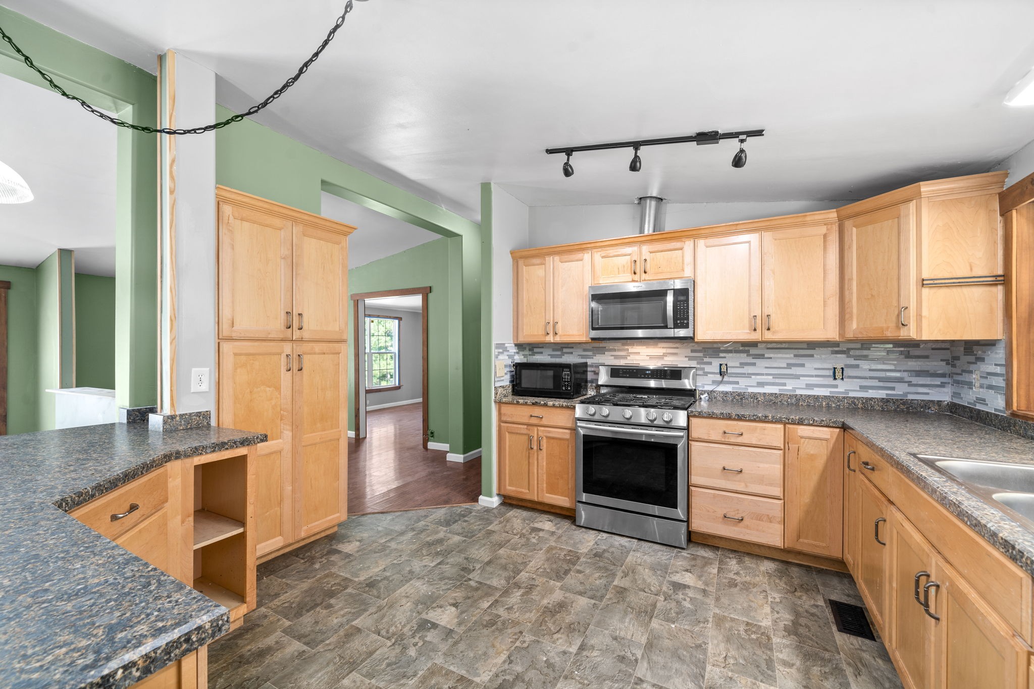 107 Holland Road Dickson, TN 37055 - Photo 9 of 31 a kitchen with stainless steel appliances granite countertop a stove a sink and a refrigerator